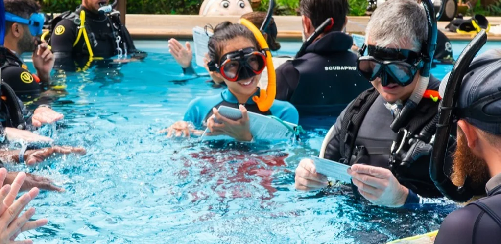 Ting teaching a course in the pool