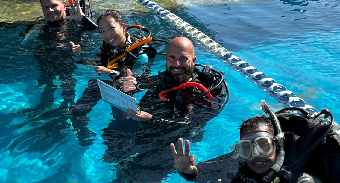 Ting and Alex teaching a course in the pool